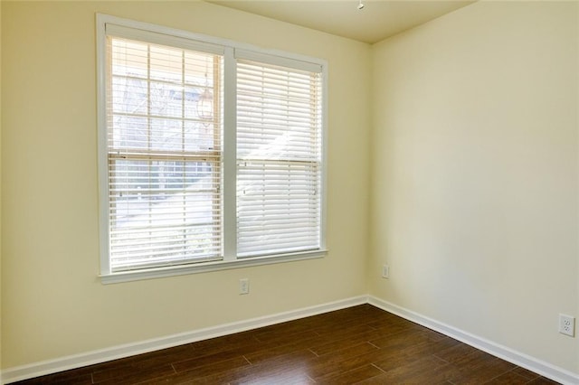 spare room featuring dark wood-type flooring