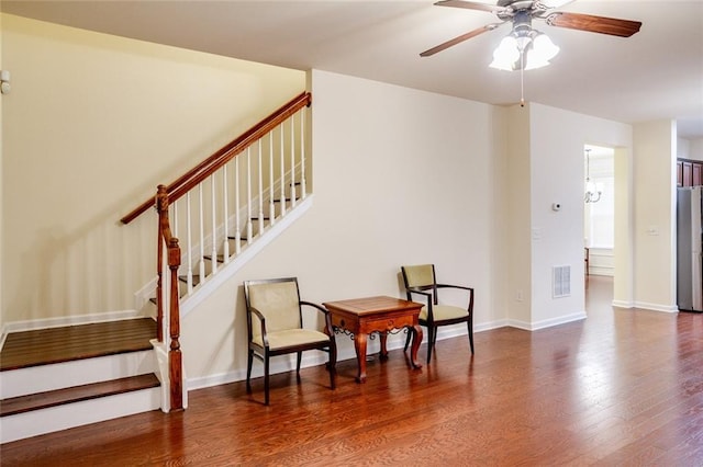 living area featuring dark hardwood / wood-style flooring and ceiling fan