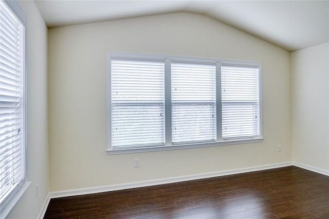 empty room featuring lofted ceiling and dark hardwood / wood-style floors