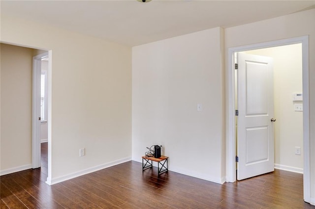 spare room with dark wood-type flooring