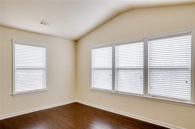 empty room with lofted ceiling and dark hardwood / wood-style flooring