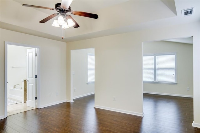 unfurnished room featuring dark wood-type flooring and ceiling fan