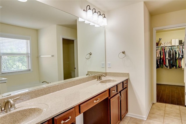 bathroom with vanity, tile patterned flooring, and a washtub