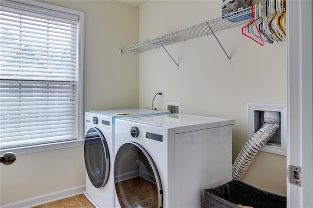 laundry area featuring a wealth of natural light and washing machine and clothes dryer