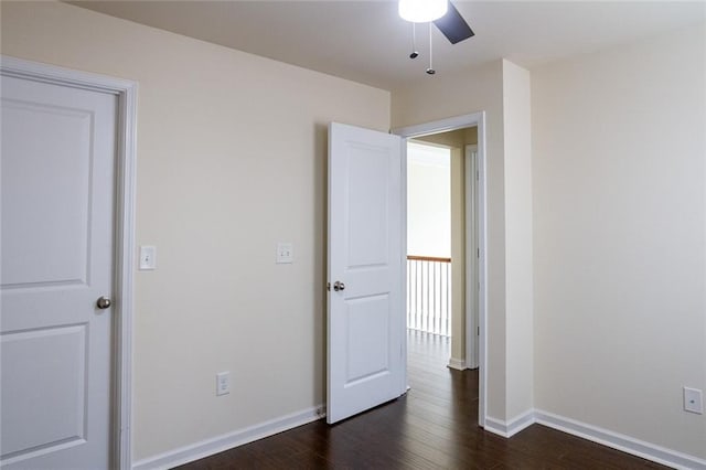 unfurnished bedroom with ceiling fan and dark hardwood / wood-style floors