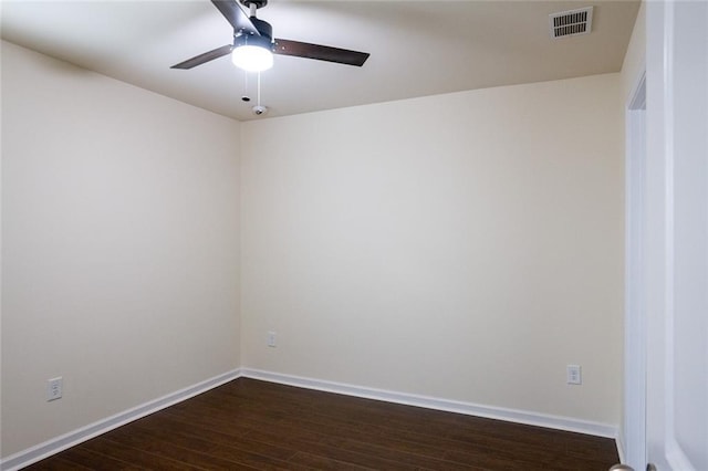 empty room featuring dark wood-type flooring and ceiling fan