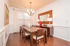 dining area with ornamental molding, dark hardwood / wood-style floors, and a chandelier