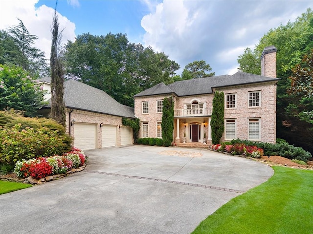 view of front of home with a front lawn and a garage