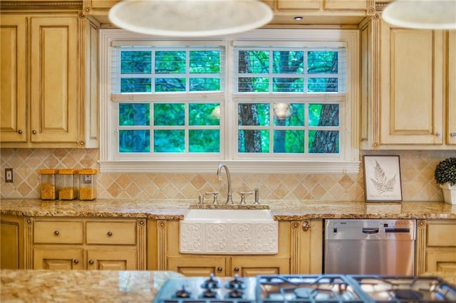 kitchen featuring backsplash, stainless steel dishwasher, and light stone countertops