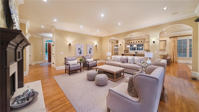 living room with light hardwood / wood-style flooring and ornamental molding