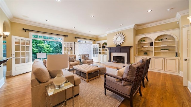 living room featuring light hardwood / wood-style flooring and crown molding