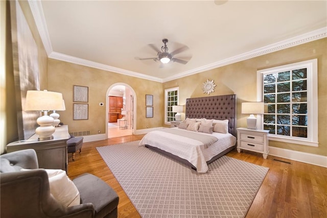 bedroom featuring ceiling fan, light hardwood / wood-style flooring, and ornamental molding