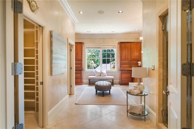 hallway featuring light tile floors and crown molding