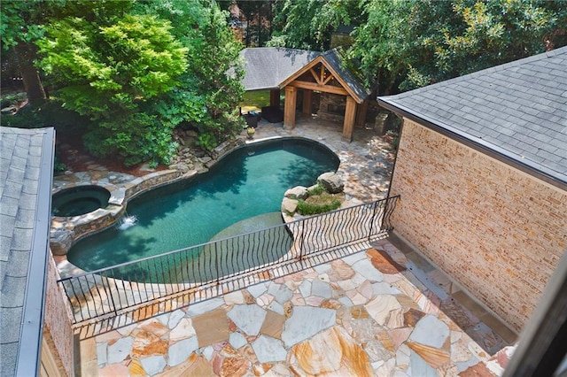 view of swimming pool featuring a patio area, an in ground hot tub, and a gazebo