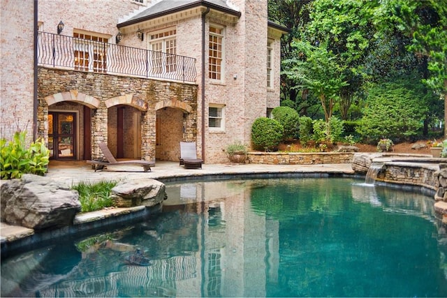 view of pool with a jacuzzi and pool water feature