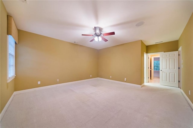 carpeted spare room with ceiling fan