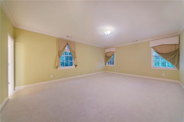 spare room featuring ornamental molding and light colored carpet