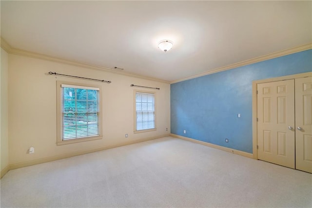 carpeted empty room featuring ornamental molding