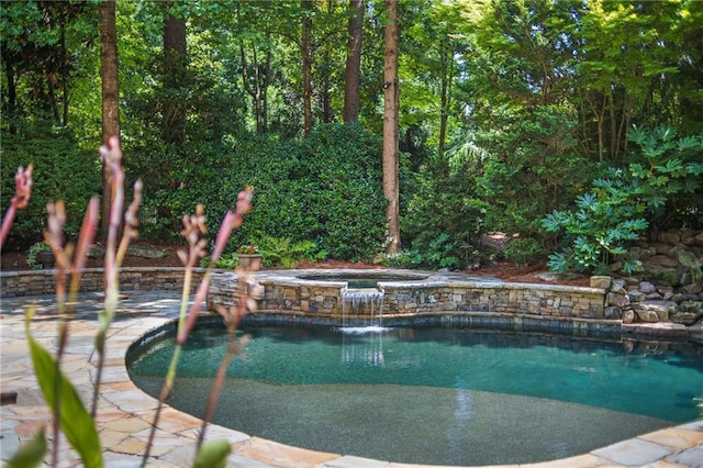 view of swimming pool featuring an in ground hot tub