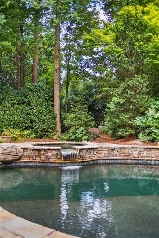 view of swimming pool featuring pool water feature