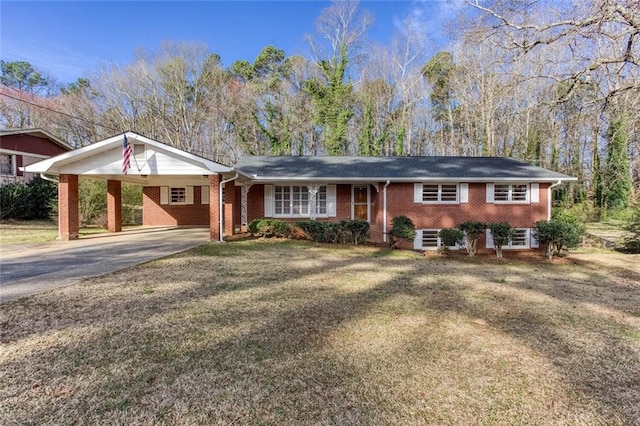 single story home featuring an attached carport, brick siding, and driveway