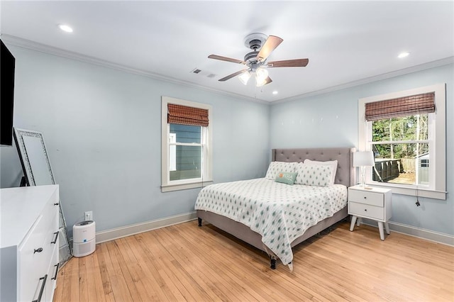 bedroom featuring ceiling fan, crown molding, and light hardwood / wood-style floors