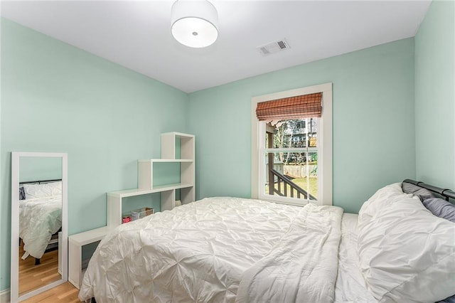 bedroom with hardwood / wood-style flooring