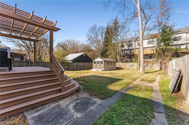 view of yard with a pergola, a wooden deck, and a storage shed