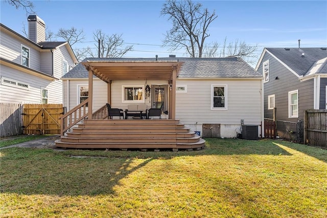 rear view of house featuring central AC, a yard, and a wooden deck