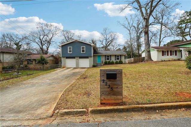 tri-level home with a garage and a front lawn