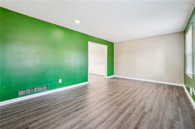 spare room featuring hardwood / wood-style floors