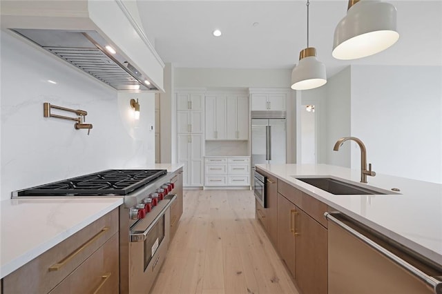 8200 Main St Unit 1206, Woodstock, GA 30188 - kitchen featuring high quality appliances, custom range hood, a sink, light wood-style floors, and light countertops