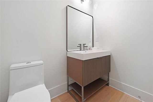8200 Main St Unit 1206, Woodstock, GA 30188 - bathroom featuring vanity, toilet, and wood finished floors