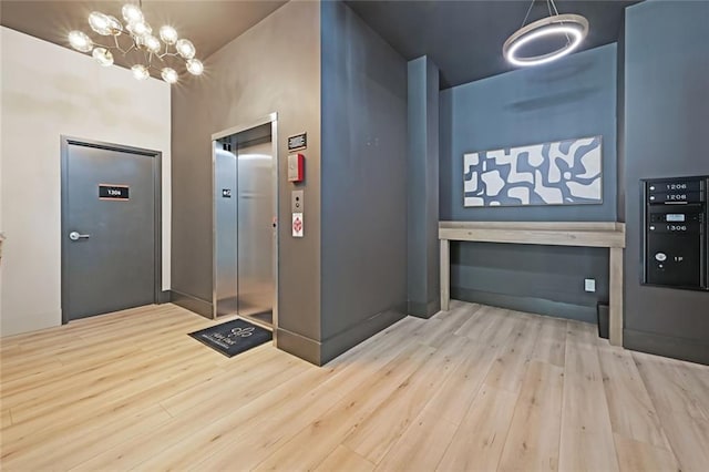 8200 Main St Unit 1206, Woodstock, GA 30188 - entrance foyer featuring elevator, wood finished floors, and a chandelier