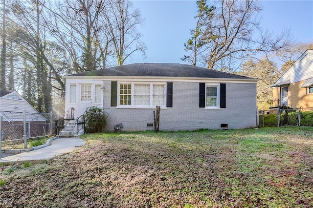 view of front of property featuring brick siding, crawl space, a front lawn, and fence