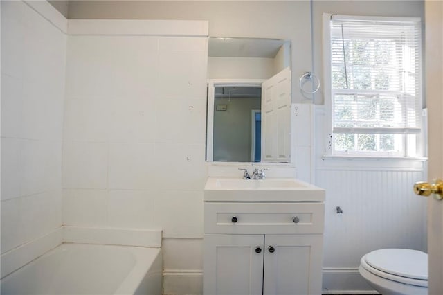 bathroom with a tub to relax in, toilet, and vanity