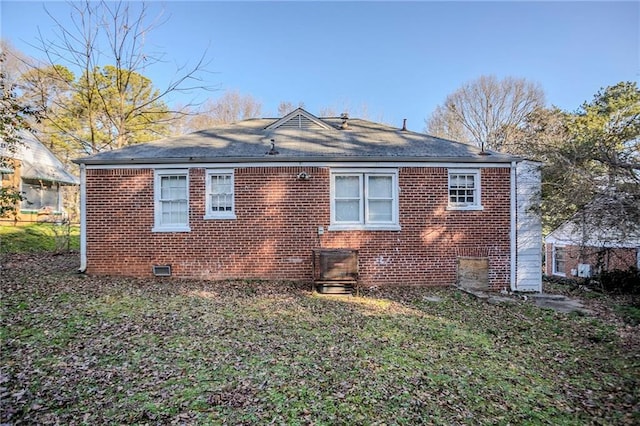 exterior space featuring crawl space, a yard, and brick siding