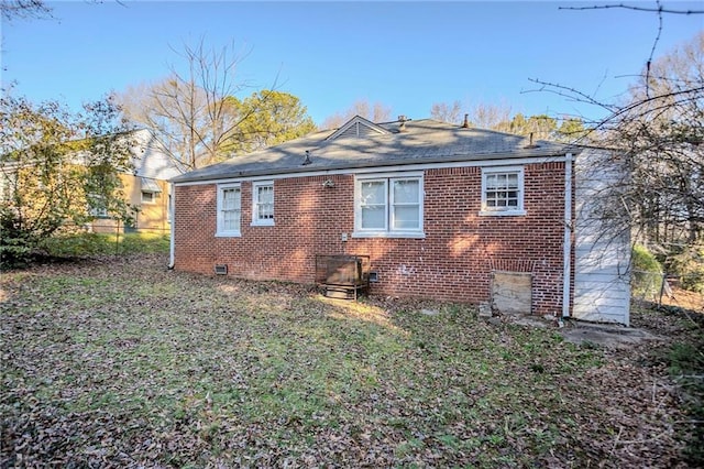 view of home's exterior with brick siding, crawl space, and a lawn