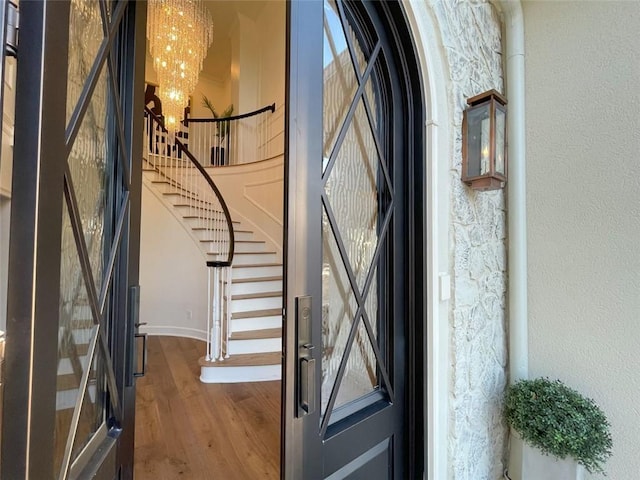 2470 Hopewell Plantation Dr, Alpharetta, GA 30004 - foyer entrance featuring a chandelier, wood finished floors, and stairway