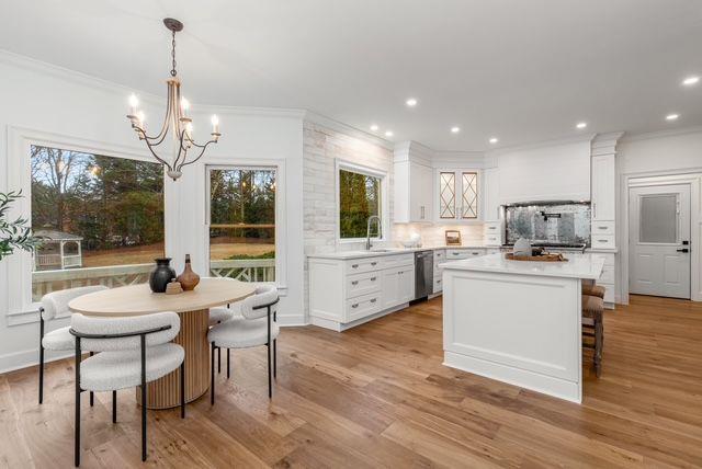 2470 Hopewell Plantation Dr, Milton, GA 30004 - kitchen with healthy amount of natural light, a chandelier, white cabinetry, decorative backsplash, and ornamental molding
