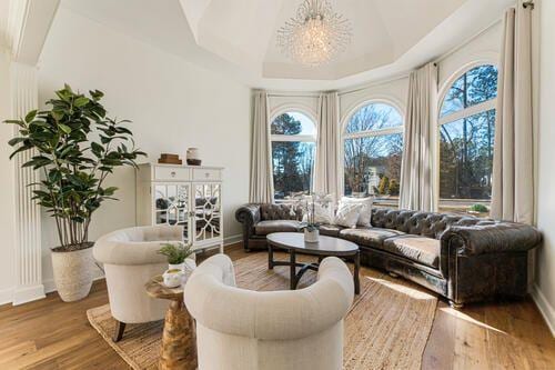 2470 Hopewell Plantation Dr, Alpharetta, GA 30004 - sitting room featuring baseboards, wood finished floors, a chandelier, and vaulted ceiling