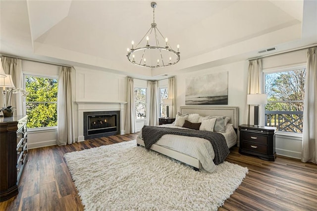 2470 Hopewell Plantation Dr, Milton, GA 30004 - bedroom featuring a raised ceiling, a chandelier, and multiple windows