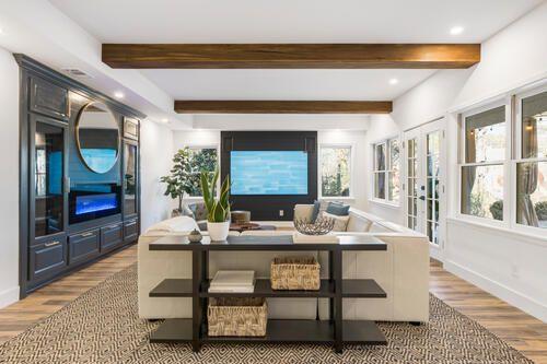 2470 Hopewell Plantation Dr, Alpharetta, GA 30004 - living room featuring wood finished floors, healthy amount of natural light, beam ceiling, baseboards, and a fireplace