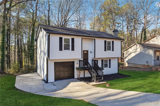 split foyer home featuring a front yard and a garage