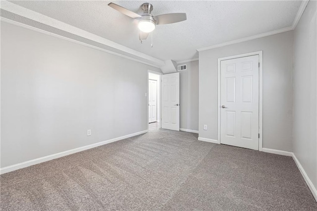 unfurnished bedroom with carpet flooring, ceiling fan, crown molding, and a textured ceiling