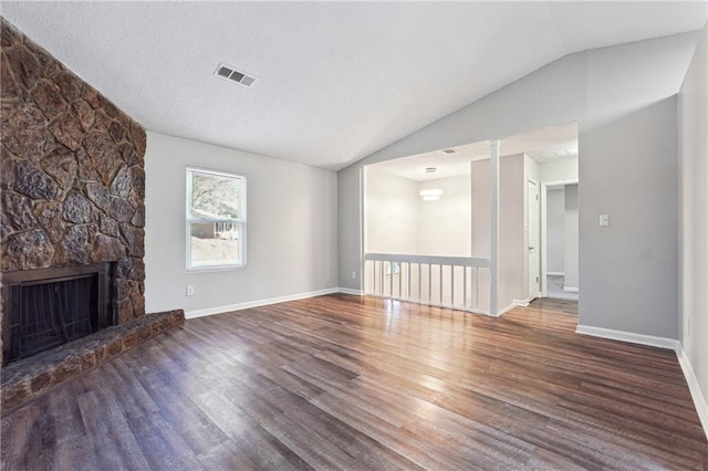 unfurnished living room with dark hardwood / wood-style floors, lofted ceiling, and a fireplace