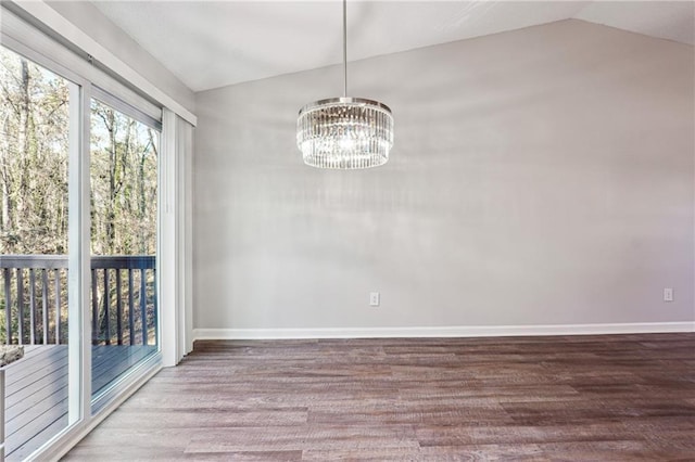 unfurnished dining area with wood-type flooring, lofted ceiling, and a chandelier