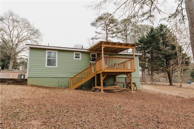 rear view of property featuring a wooden deck