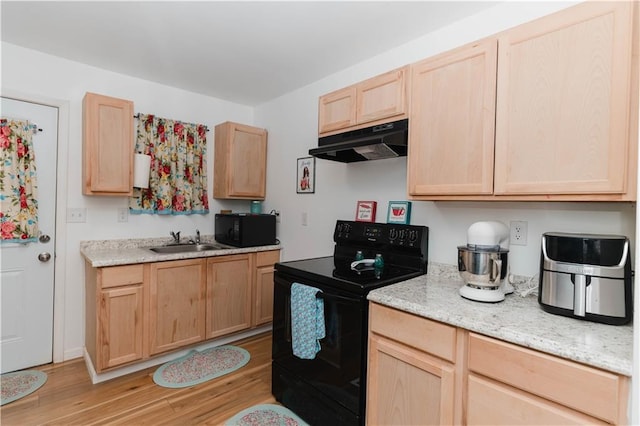 kitchen with black appliances, light brown cabinetry, sink, light wood-type flooring, and light stone counters