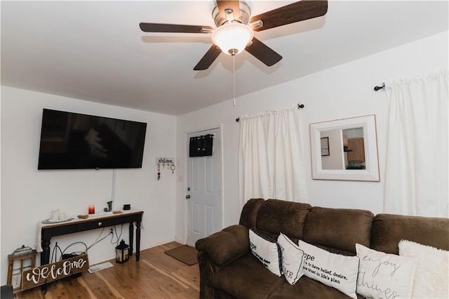 living room featuring hardwood / wood-style flooring and ceiling fan